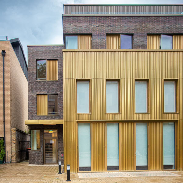 A brass profiled metal facade in a building with lots of windows in Lonion